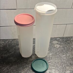 Two Spaghetti Tall Storage Containers with Lids. One has guide for measuring